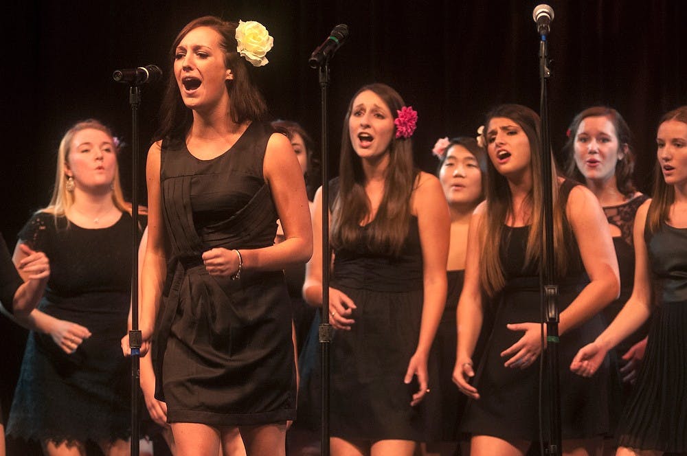 	<p>Advertising senior Paige Bolen sings a solo with Ladies First Oct. 25, 2013, at the Hannah Community Center during Acapalooza. Acapalooza brought seven of <span class="caps">MSU</span>&#8217;s accapella groups to perform Friday and Saturday night under one roof. Margaux Forster/The State News</p>