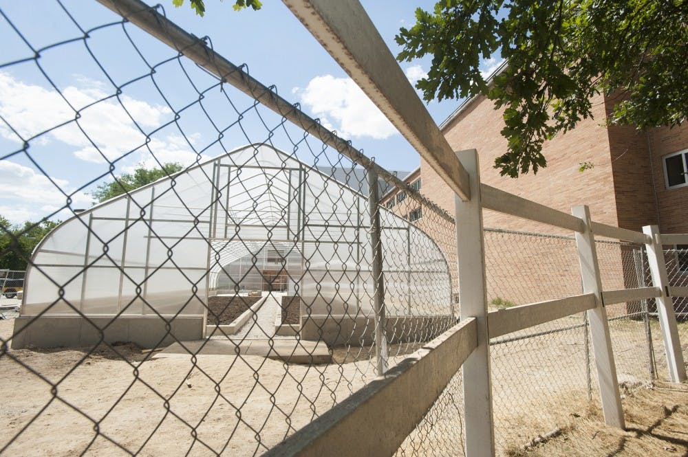 A greenhouse is being built at the south side of Bailey Hall on Tuesday July 11, 2012. When finished, the plants produced in this site would serve for Brody Complex Cafeteria. Justin Wan/The State News