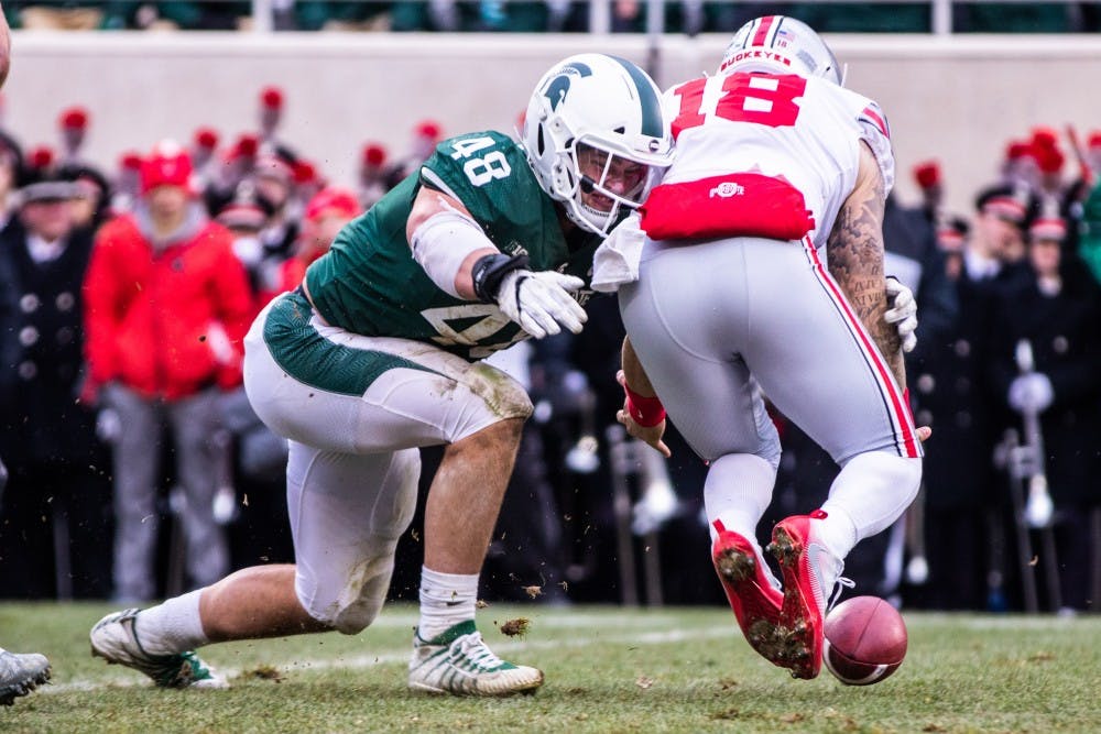 Junior defensive end Kenny Willekes (48) hits Ohio State quarterback Tate Martell (18) as the ball falls loose during the game Nov. 10, 2018. The Spartans fell to the Buckeyes, 26-6.