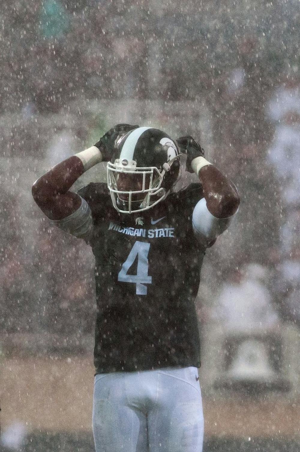 <p>Sophomore defensive lineman Malik McDowell tries to pump up the crowd during a brief moment of hard rain during the game against Indiana on Oct. 24, 2015, at Spartan Stadium. The Spartans defeated the Hoosiers, 52-26.</p>