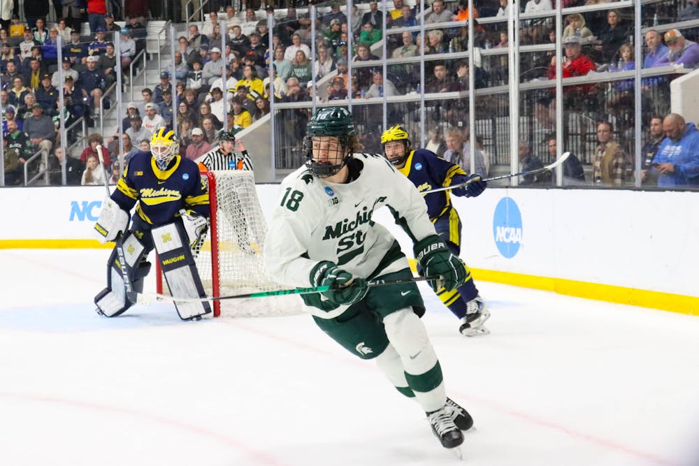 <p>Sophomore forward Joey Larson beats the opponent to the puck, and is able to keep it in the Wolverines' end in the NCAA Regional tournament against Michigan at Centene Ice Center on March 31, 2024.</p>