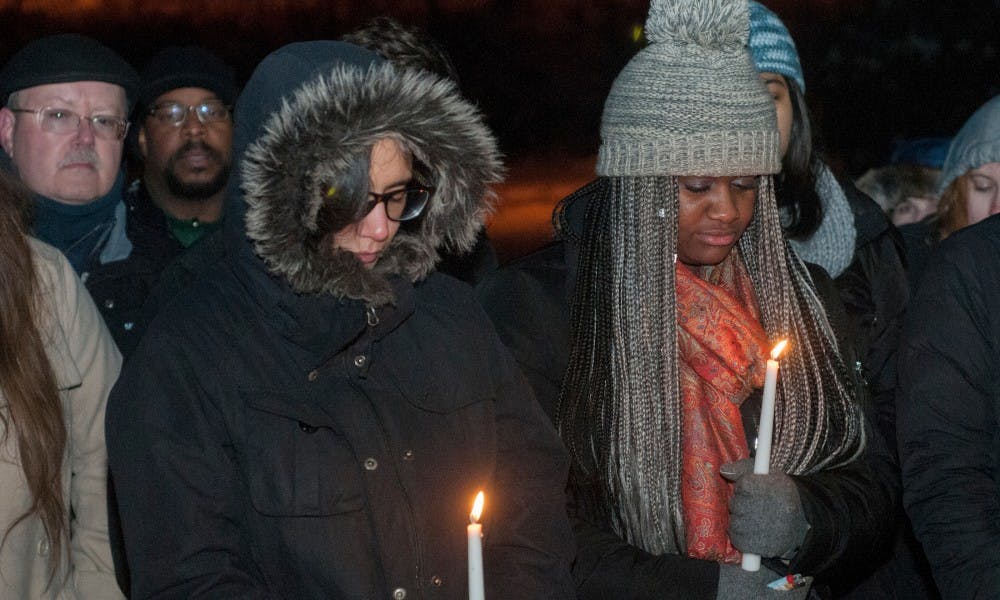 Business senior exchange student from France, Leia Rigoreau, left and French sophomore Adrianna Davis attend a vigil to honor the departed in recent terrorist attacks across the globe on Nov. 22, 2015 at The Rock on Farm Lane. 