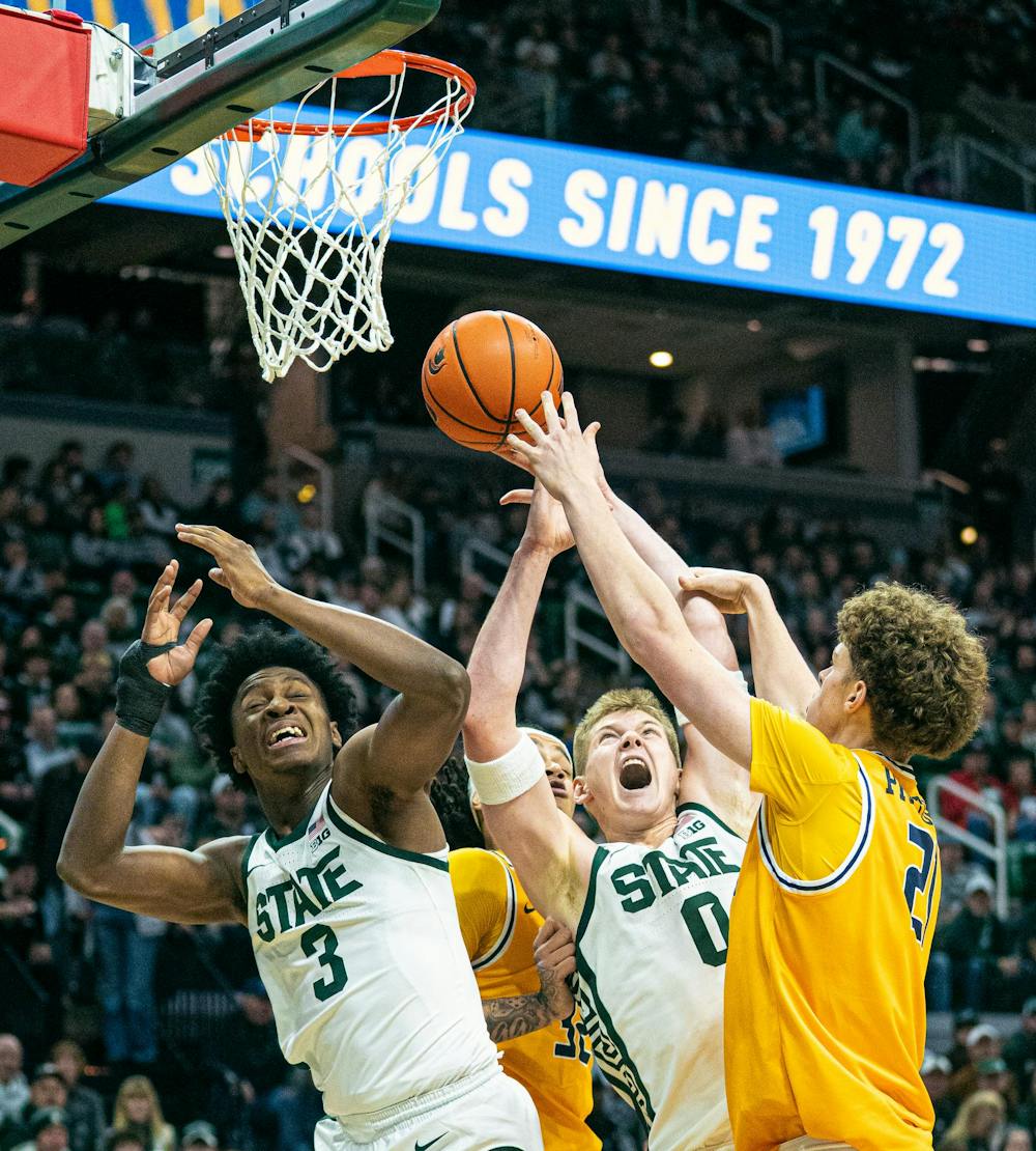 <p>MSU senior forward, Jaxon Kohler (0) and freshman forward, Cam Ward (3) leap into the air as Toledo freshman forward, London Praytor (21) tries to get his hands on the ball during the MSU versus Toledo matchup at the Breslin Center in East Lansing, Michigan on Tuesday, Dec. 16, 2025.</p>