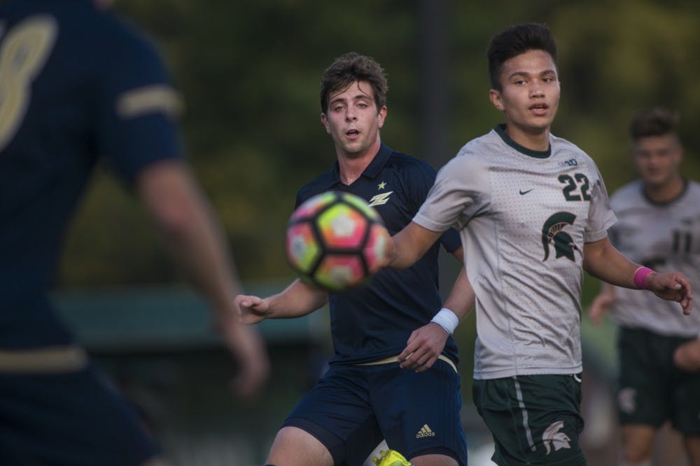 <p>Midfielder Ken Krolicki (22) attempts to block Akron midfielder Pau Belana (13) on a pass during the first half of the game on Oct. 11, 2016 at DeMartin Stadium at Old College Field. The Spartans defeated the Zips, 2-1.</p>