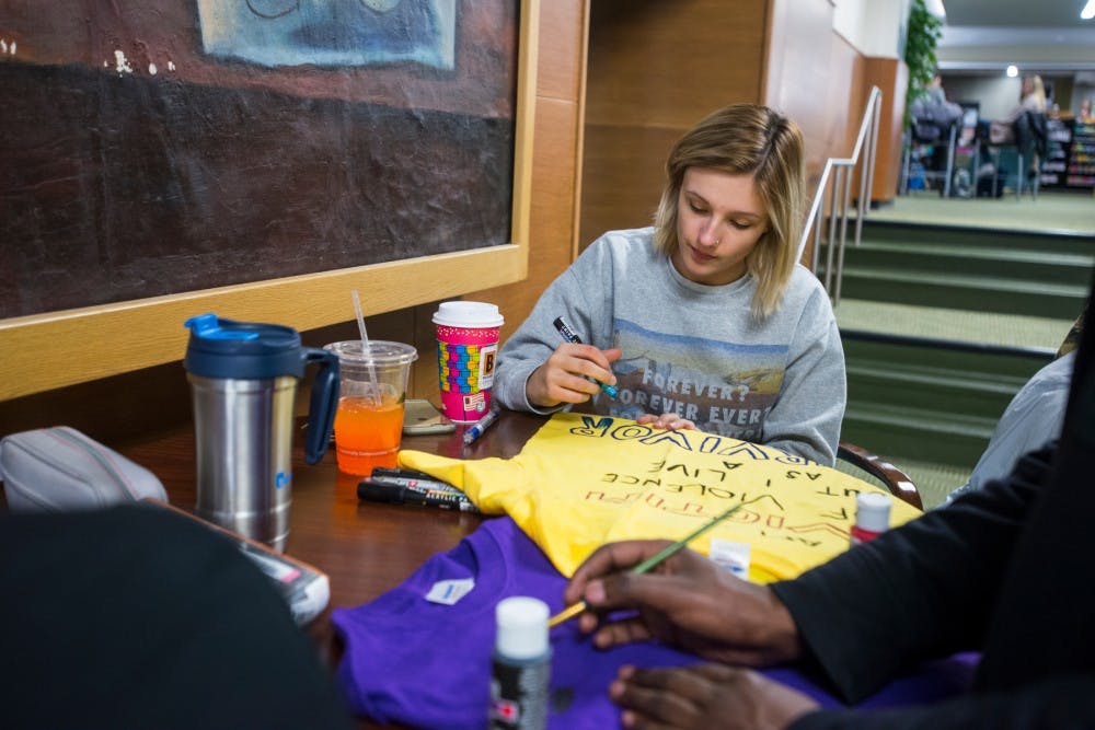 Social work senior Sierra Petersen designs a t-shirt for The Clothesline Project on April 7, 2016 at the Union. The Clothesline Project celebrates the strength and courage of women who survived acts of violence. 