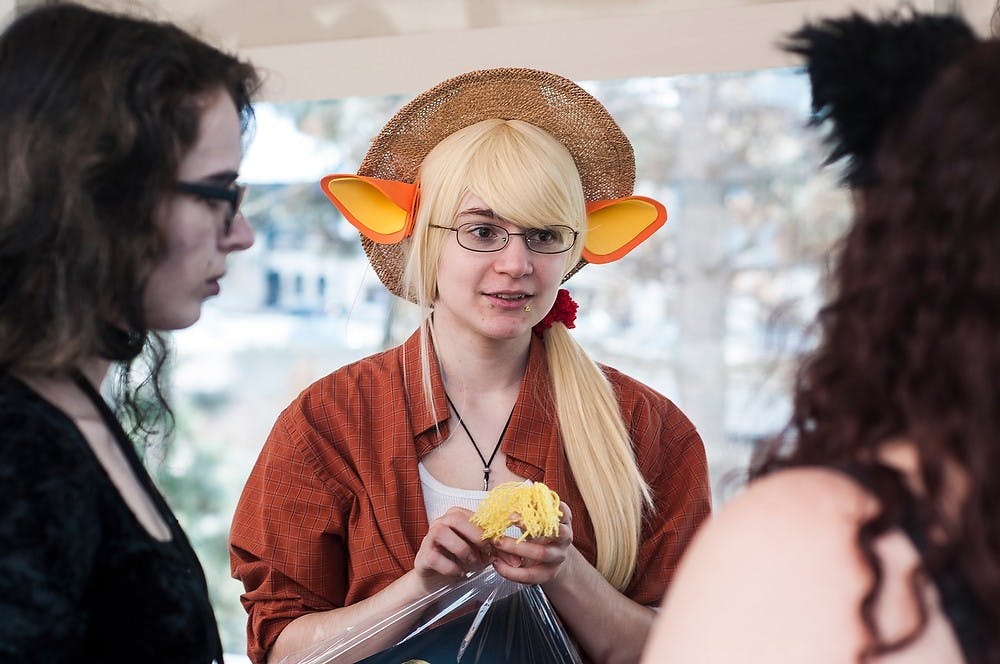 <p>Lansing resident Sarah Thornton talks with her friends April 6, 2014, at Shuto Con at the Lansing Center and the Radisson Hotel in Lansing. Thornton was dressed as Apple Jack from &#8220;My Little Pony.&#8221; Shuto Con is an annual convention in Lansing centered around anime, artists and interactive cosplay. Erin Hampton/The State News</p>