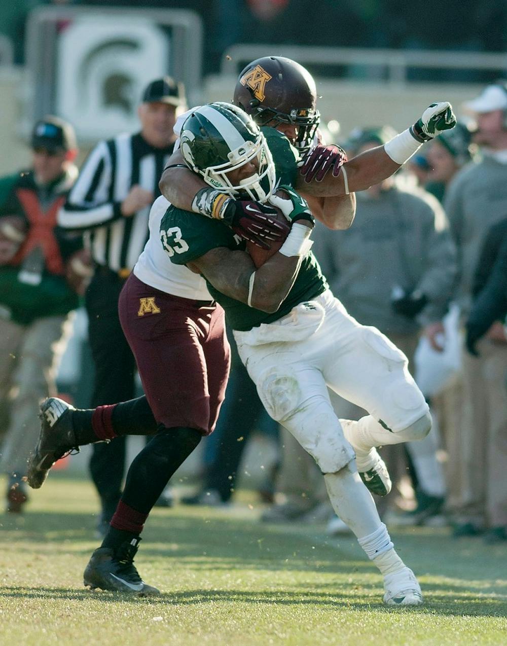 	<p>Minnesota linebacker Aaron Hill tackles junior running back Jeremy Langford on Nov. 30, 2013, at Spartan Stadium. The Spartans defeated the Golden Gophers, 14-3. Danyelle Morrow/The State News</p>