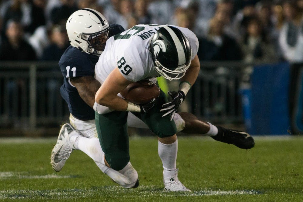 <p>Then-sophomore tight end Matt Dotson (89) is tackled during the game against Penn State at Beaver Stadium on Oct. 13, 2018. The Spartans defeated the Nittany Lions 21-17.</p>