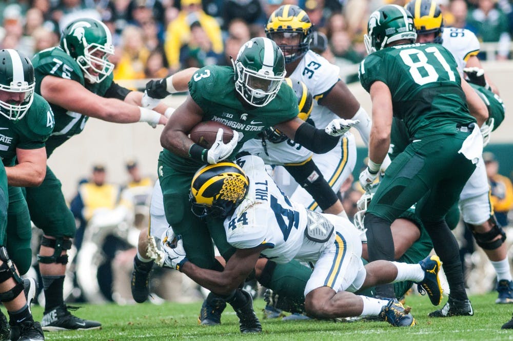 Sophomore running back LJ Scott (3) runs the football during the game against the University of Michigan on Oct. 29, 2016 at Spartan Stadium. The Spartans were defeated by the Wolverines, 32-23.