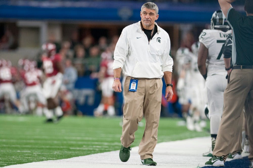 Head strength and conditioning coach Ken Mannie reacts to an Alabama touchdown in the third quarter during the Goodyear Cotton Bowl Classic against Alabama on Dec. 31, 2015 at AT&T Stadium in Arlington, Texas. The Crimson Tide defeated the Spartans, 38-0.