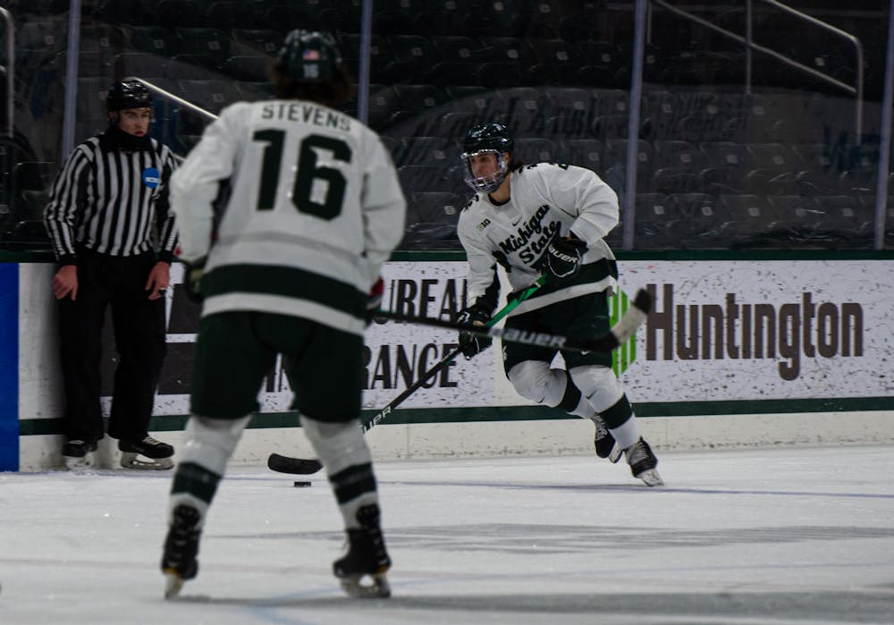 <p>Freshman right defender Aiden Gallacher (2) skates with the puck to find an open teammate in the first period. The Spartans fell to the Buckeyes, 1-5, at Munn Ice Arena on Jan. 23, 2020.</p>