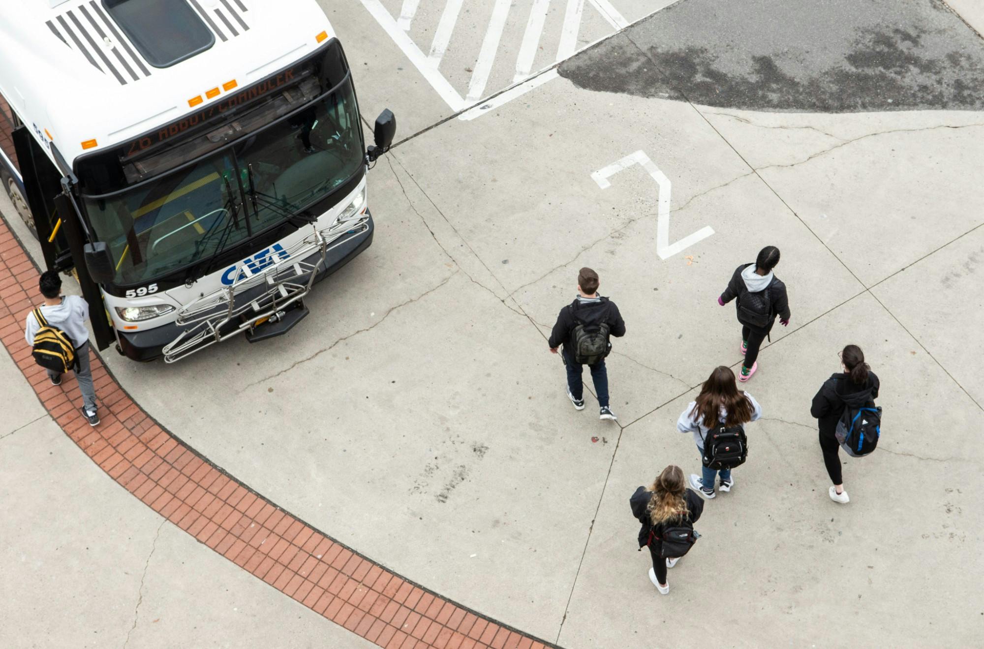 <p>Students board a CATA bus after an email was released notifying students that MSU canceled classes after noon March 11, 2020.</p>