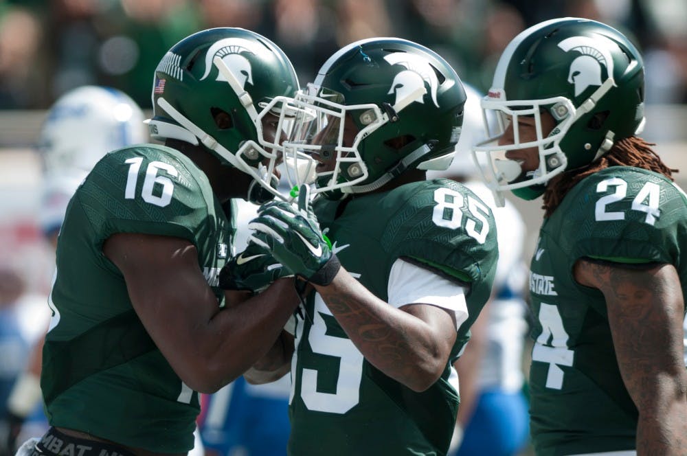 <p>Senior wide receiver Aaron Burbridge, 16, and senior wide receiver Macgarrett Kings Jr., 85, celebrate Burbridge's touchdown in the first half during the game against Air Force on Sept. 19, 2015 at Spartan Stadium. The Spartans defeated the Falcons, 35-21. </p>