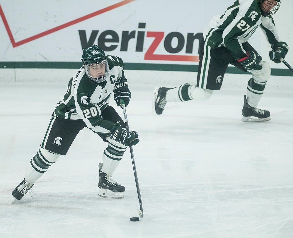 <p>Junior forward Michael Ferrantino runs the puck down the ice Oct. 31, 2014 during a game against Ferris State at Munn Ice Arena. The Bulldogs defeated the Spartans, 1-0. Erin Hampton/The State News</p>