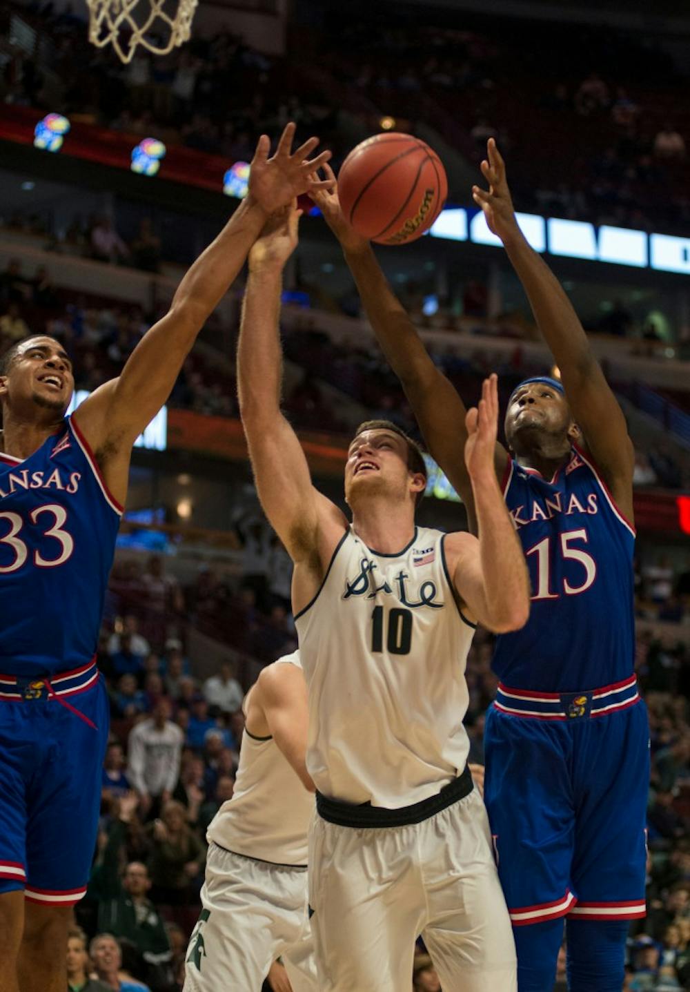 <p>Then-senior forward Matt Costello defends the ball as then-Kansas forward Carlton Bragg Jr. goes for the lay-up on Nov. 17, 2015 at United Center in Chicago during the Champions Classic. The Spartans defeated the Jayhawks, 79-73. </p>