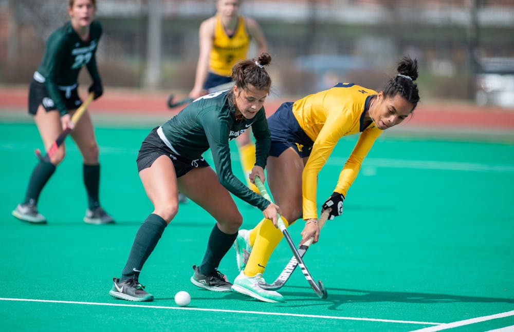 MSU midfielder Merel Hanssen, left,  steals possession from Michigan midfielder Nina Apoola, right,  during a home game on Ralph Young Field on April 2, 2021.