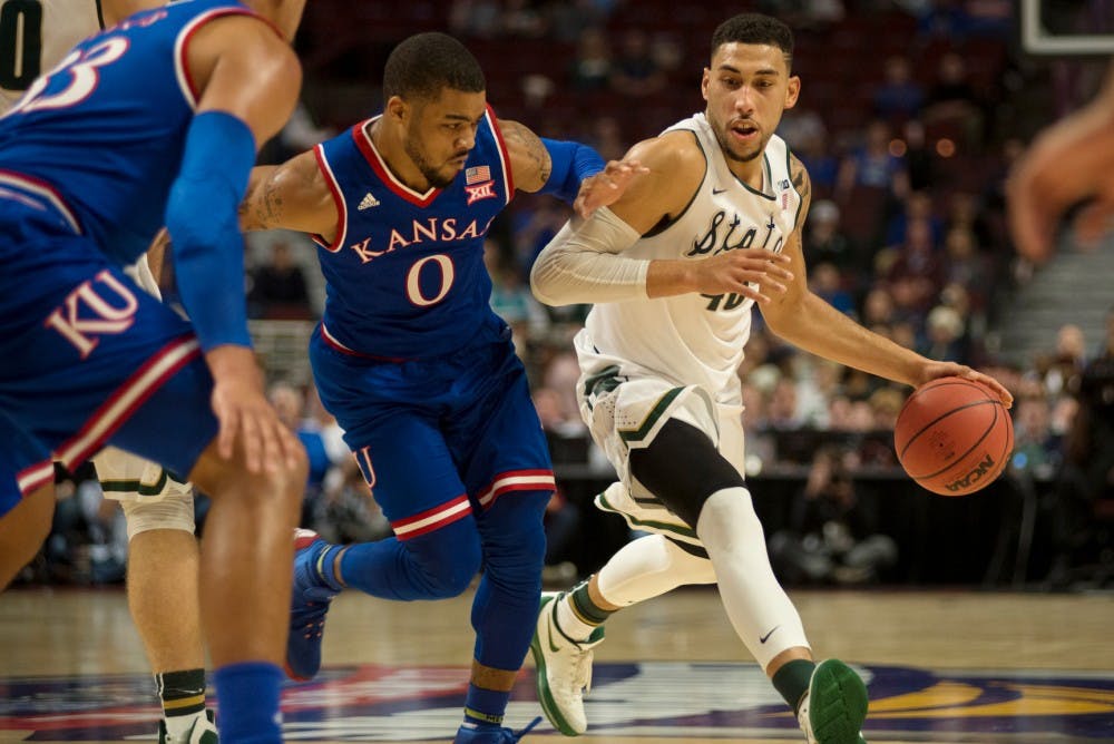 <p>Then-senior guard Denzel Valentine looks to pass the ball as Kansas guard Frank Mason III defends on Nov. 17, 2015 at United Center in Chicago during the Champions Classic. The Spartans defeated the Jayhawks, 79-73.</p>