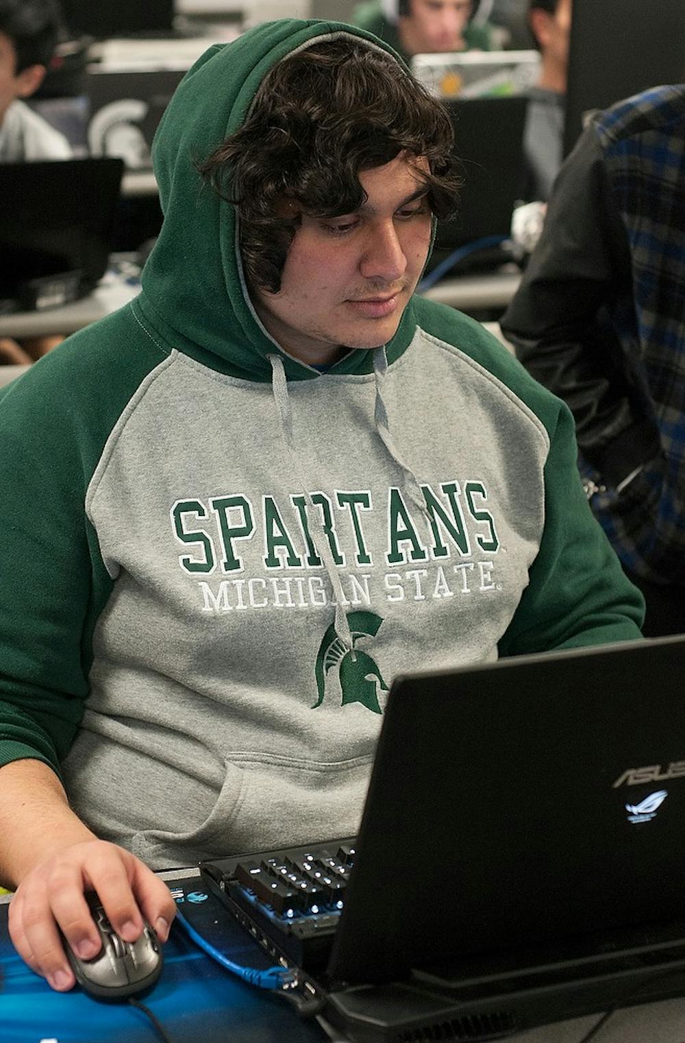 <p>Political theory and constitutional democracy sophomore Marcus Muallem plays a game March 28, 2015 during the MSU March SoloQ tournament at the Engineering Building on 428 S Shaw Ln. The event was attended by approximately 50 students and alumni, who are members of the MSU League of Legends Club. Alice Kole/The State News </p>