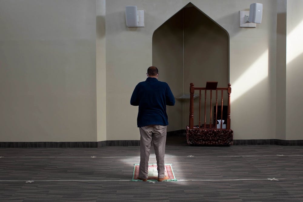 <p>Thasin Sarder continues his prayer in the East Lansing Islamic Center&#x27;s prayer room. Shot on Feb. 10, 2021.</p>