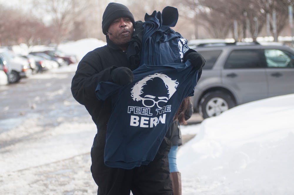 A vendor sells 'Feel The Bern' shirts to individuals waiting in line prior to Bernie Sanders' speech on March. 2, 2016 at Breslin Center.