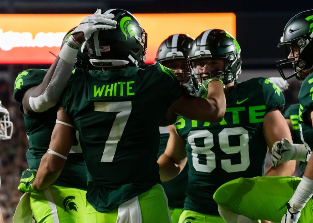 <p>Junior wide receiver Cody White (7) celebrates with his teammates after a touchdown against Western Michigan. The Spartans defeated the Broncos, 51-17, on Sept. 7, 2019 at Spartan Stadium.</p>