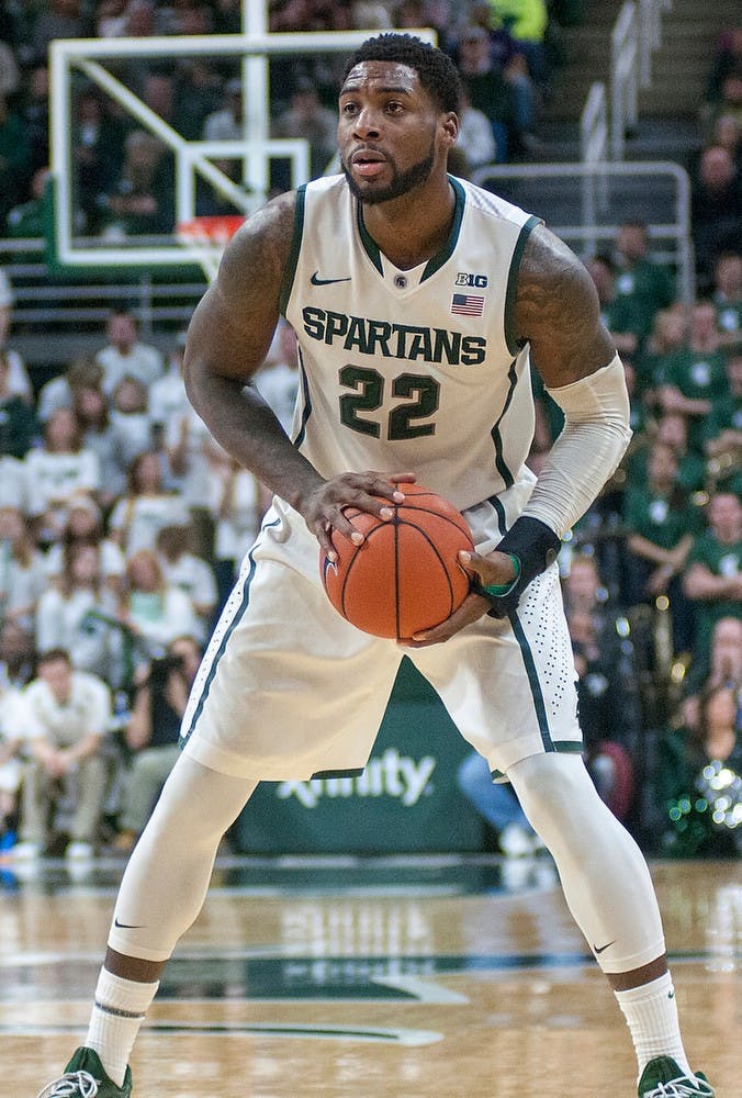 <p>Senior forward/guard Branden Dawson looks to pass Jan. 11, 2015, during the game against Northwestern at Breslin Center. The Spartans defeated the Wildcats, 84-77 in overtime. Kelsey Feldpausch/The State News.</p>