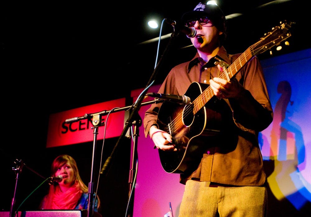 Lansing resident Brandon John Foote plays guitar as his wife and bandmate Bethany Foote sings during a performance at SCENE Metrospace as the band Gifts or Creatures on Jan. 29, 2010. The fourth annual folk festival will be held this Friday, Feb. 11.