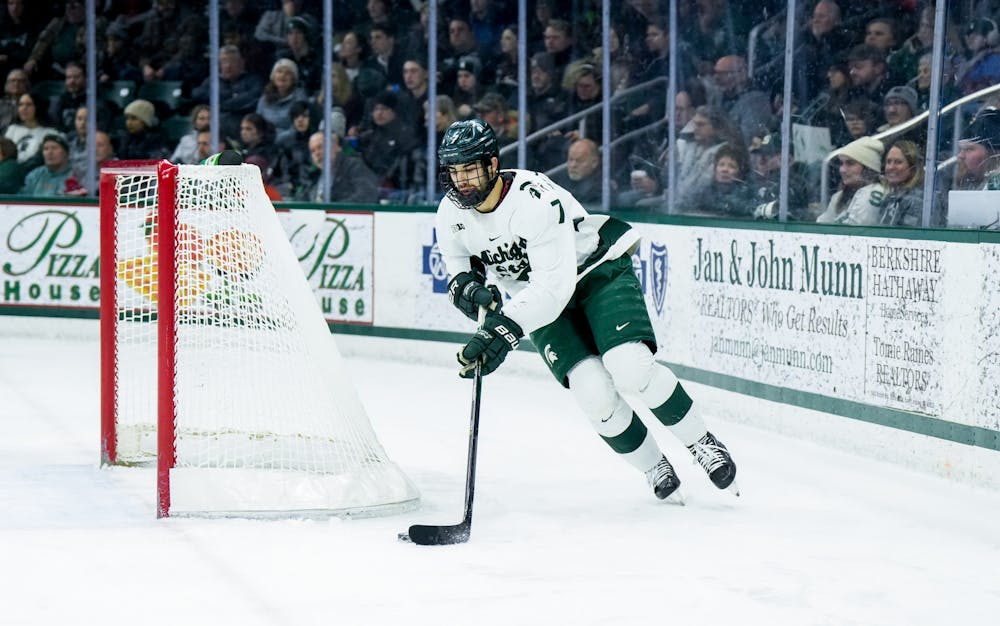 <p>Sophomore defender David Gucciardi (7) collects the puck during a game against Notre Dame at Munn Ice Arena on Feb. 3, 2023. The Spartans defeated the Fighting Irish 3-0.</p>