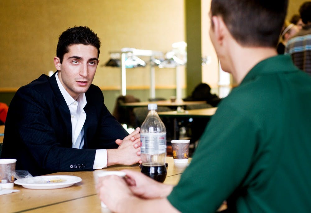 Nicholas Bucca, an ASMSU representative for the Broad College of Business, left, talks with Matt York, ASMSU vice chairperson for internal affairs with student assembly, Tuesday in the International Center. ASMSU held a meet and greet for current representatives, new candidates, and students to learn more about each other and who will be serving them next year. Matt Radick/The State News