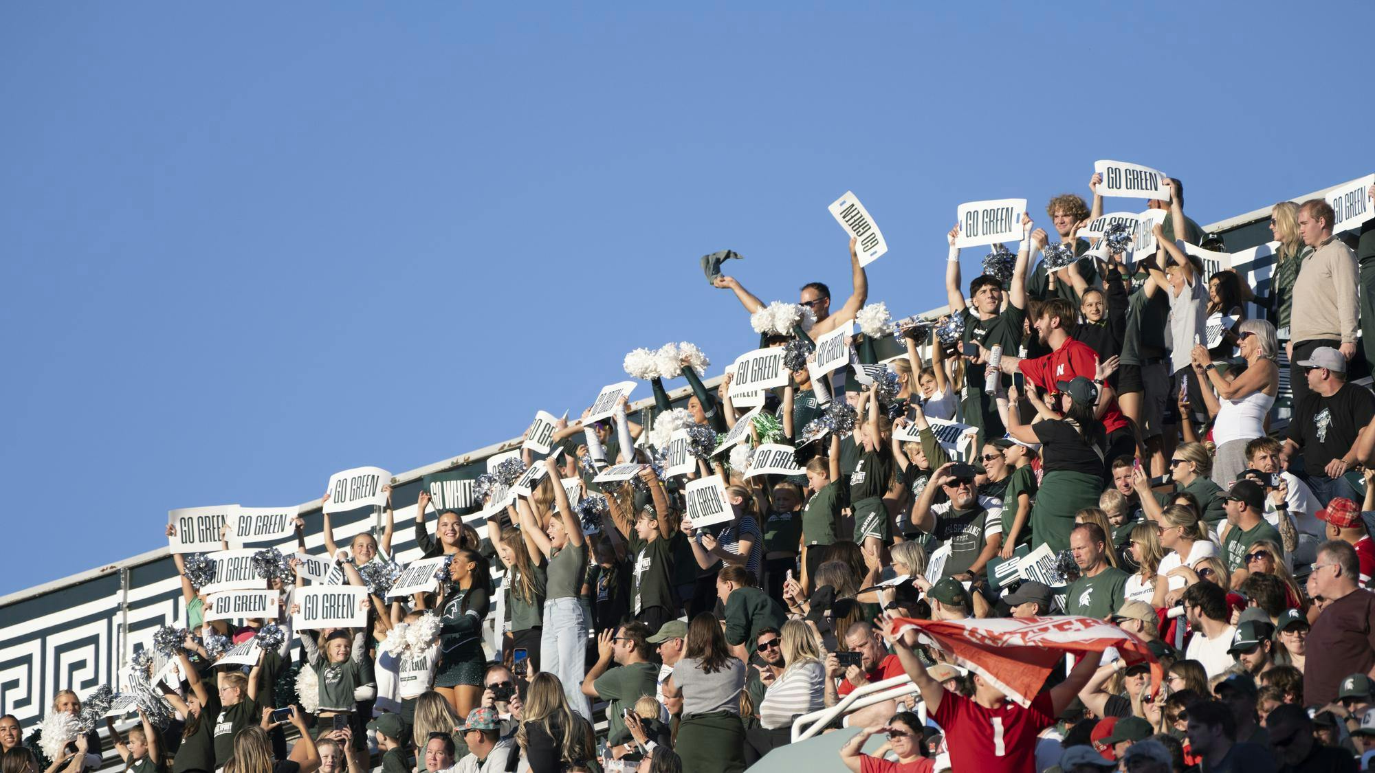 <p>Michigan State fans wave “Go Green” signs as a Nebraska fan waves a flag during the Spartans’ game against Nebraska at Spartan Stadium in East Lansing, Mich., on Saturday, Sept. 26, 2026.</p>