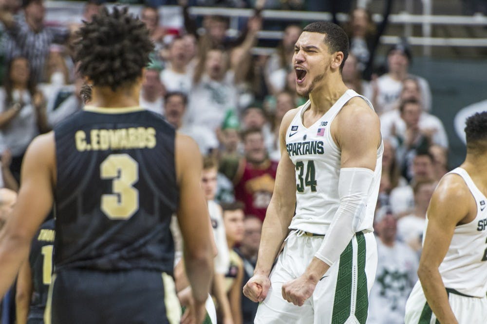 Senior forward Gavin Schilling (34) cheers during the second half of the men's basketball game against Purdue on Feb. 10, 2018 at Breslin Center. The Spartans defeated the Boilermakers, 68-65. (Nic Antaya | The State News)