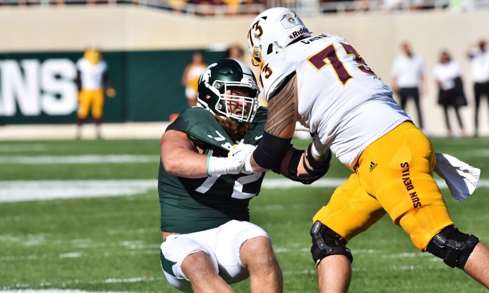<p>Senior defensive tackle Mike Panasiuk (72) defends his teammates from an Arizona State left tackle. The Spartans fell to the Sun Devils 10-7 at Spartan Stadium on Sept. 14, 2019.</p>