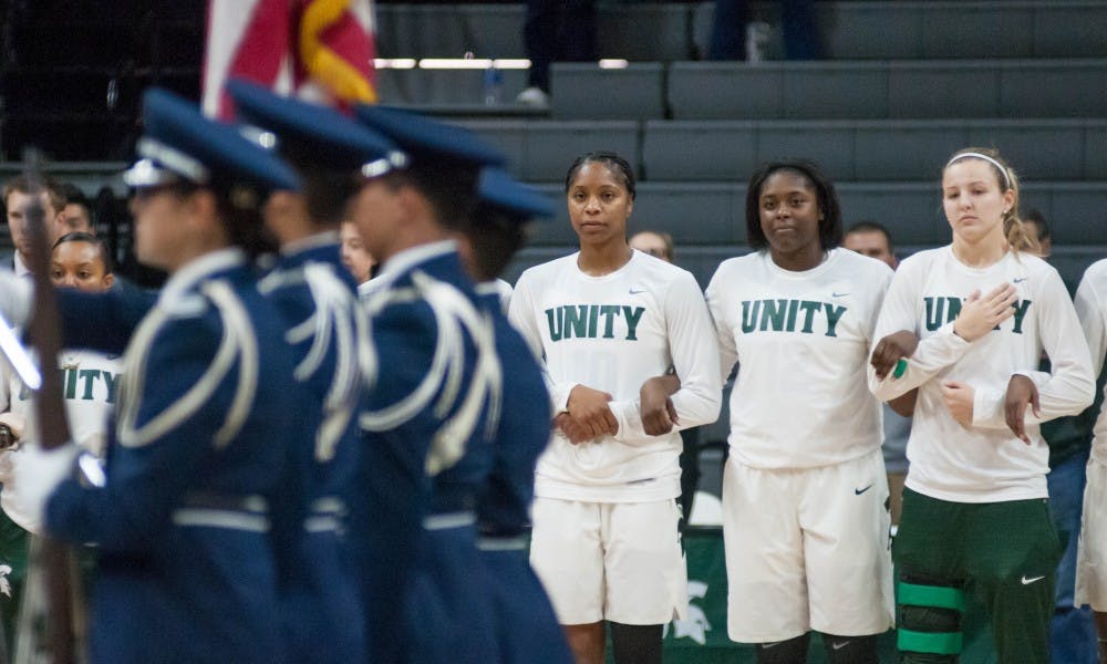 The Spartans stand during the playing of the national anthem before the game against Oakland on Nov. 13, 2017, at Breslin Center. The Spartans defeated the Grizzlies 95-63.