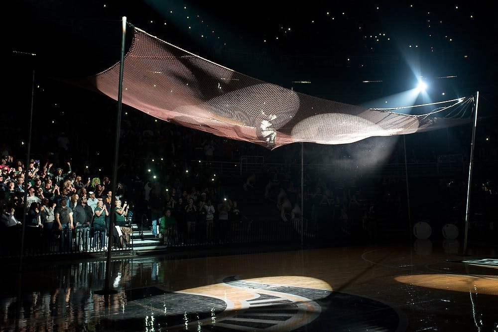 	<p>Jennifer Smith-Schneider, posing as men&#8217;s basketball head coach Tom Izzo, lands in a net after being shot out of cannon Oct. 18, 2013, during Midnight Madness at the Breslin Center. Izzo revealed after the cannon firing that it was Smith-Schneider who was actually shot out of the cannon. Julia Nagy/The State News</p>