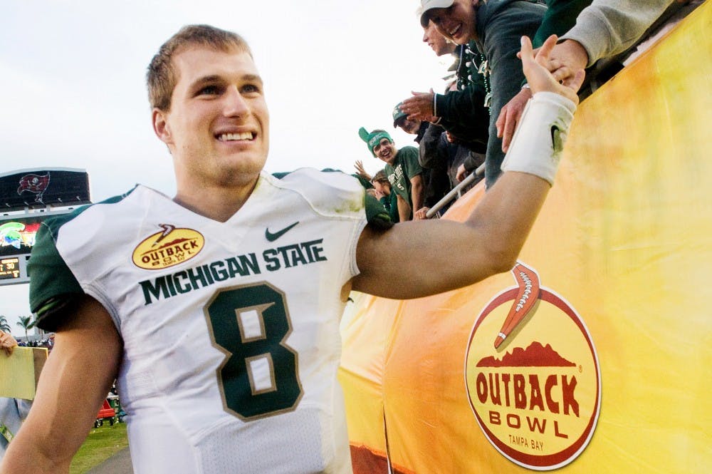 Senior quarterback Kirk Cousins celebrates with the Spartan fans. Cousins is the winninest quarterback in MSU history. The Spartans defeated the Georgia Bulldogs, 33-30, Monday afternoon at the Outback Bowl hosted in Raymond James Stadium at Tampa, Fla. after triple overtime. Justin Wan/The State News