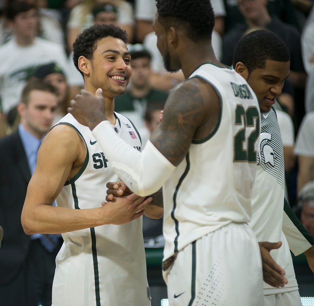 <p>Senior guard/forward Branden Dawson, 22, hugs junior guard Bryn Forbes, 5, on Mar. 4, 2015, during the senior night celebration at the game against Purdue at Breslin Center. The Spartans defeated the Boilermakers, 72-66. Emily Nagle/The State News</p>