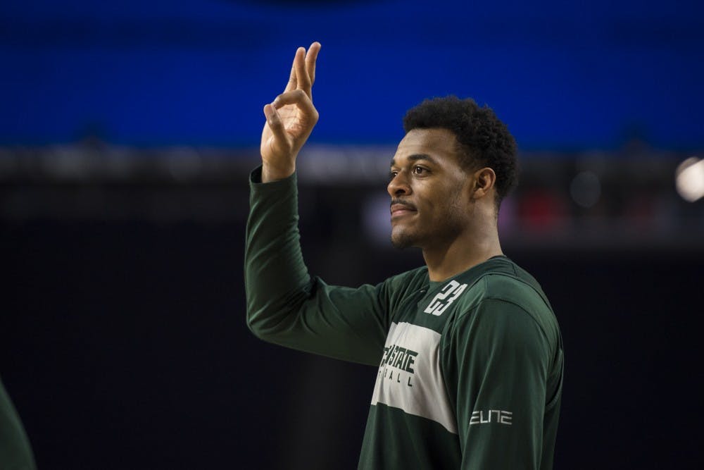 Sophomore forward Xavier Tillman (23) holds up three fingers during Michigan State's NCAA Men's Basketball Final Four open practice at U.S. Bank Stadium in Minneapolis on April 5, 2019. (Nic Antaya/The State News)