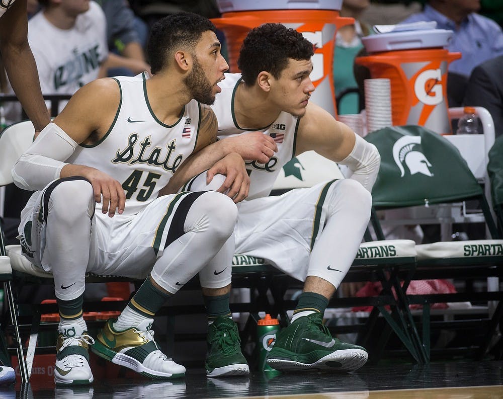 <p>Junior guard Denzel Valentine watches his teammates o the court with sophomore forward Gavin Schilling during the game against Maryland on Dec. 30, 2014, at Breslin Center. The Spartans were defeated by the Terrapins, 68-66 in double overtime. Danyelle Morrow/The State News</p>