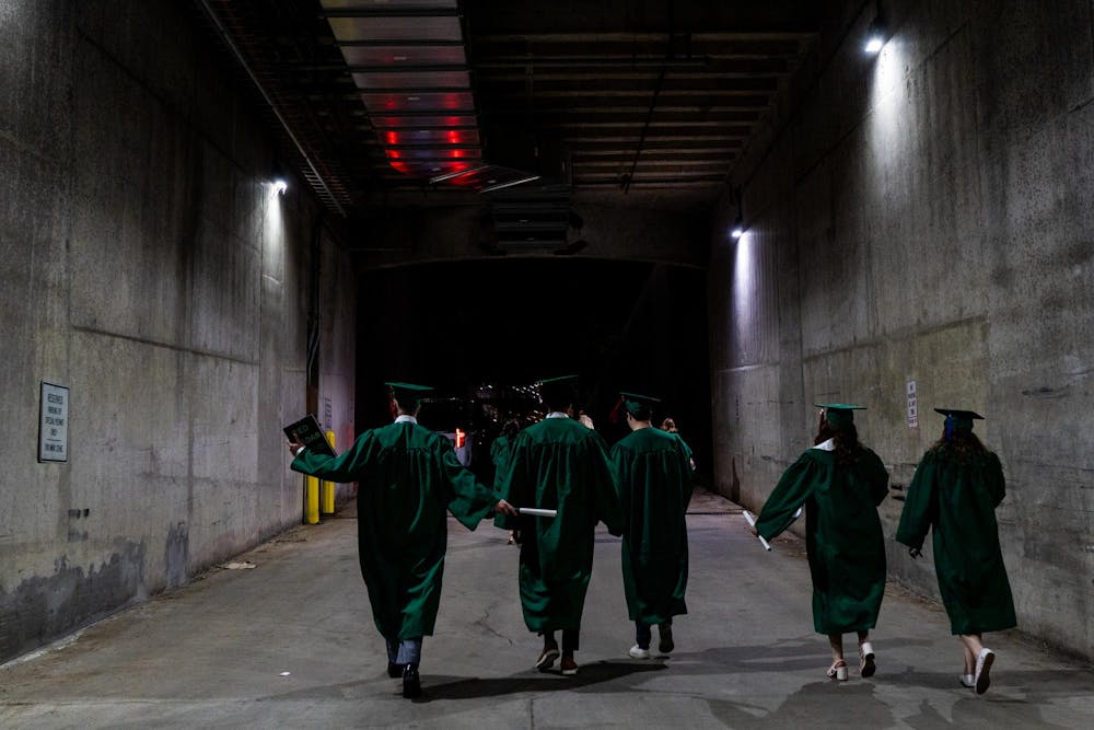Students walk up a tunnel after leaving the ceremony during the Michigan State University College of Communication Arts and Sciences graduation ceremony at the Breslin Student Events Center on Michigan State University’s campus in East Lansing, Mich., on Friday, May 1, 2026.