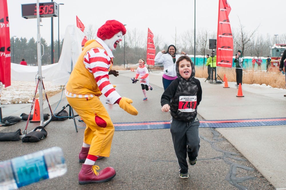 Chelsea resident Hoyt Swager, 7, right, looks to water after crossing the finish line during Run for the House on March 18, 2017 at 4100 Okemos Rd in Okemos. Run for the House is an annual marathon event that raises funds for the Ronald McDonald House of Mid-Michigan. This organization provides an alternative for families with critically ill children in hospitals: free care, shelter and food which alleviates some stresses and discomfort that may have come if the family stayed in a hospital for months while their child received treatment. 