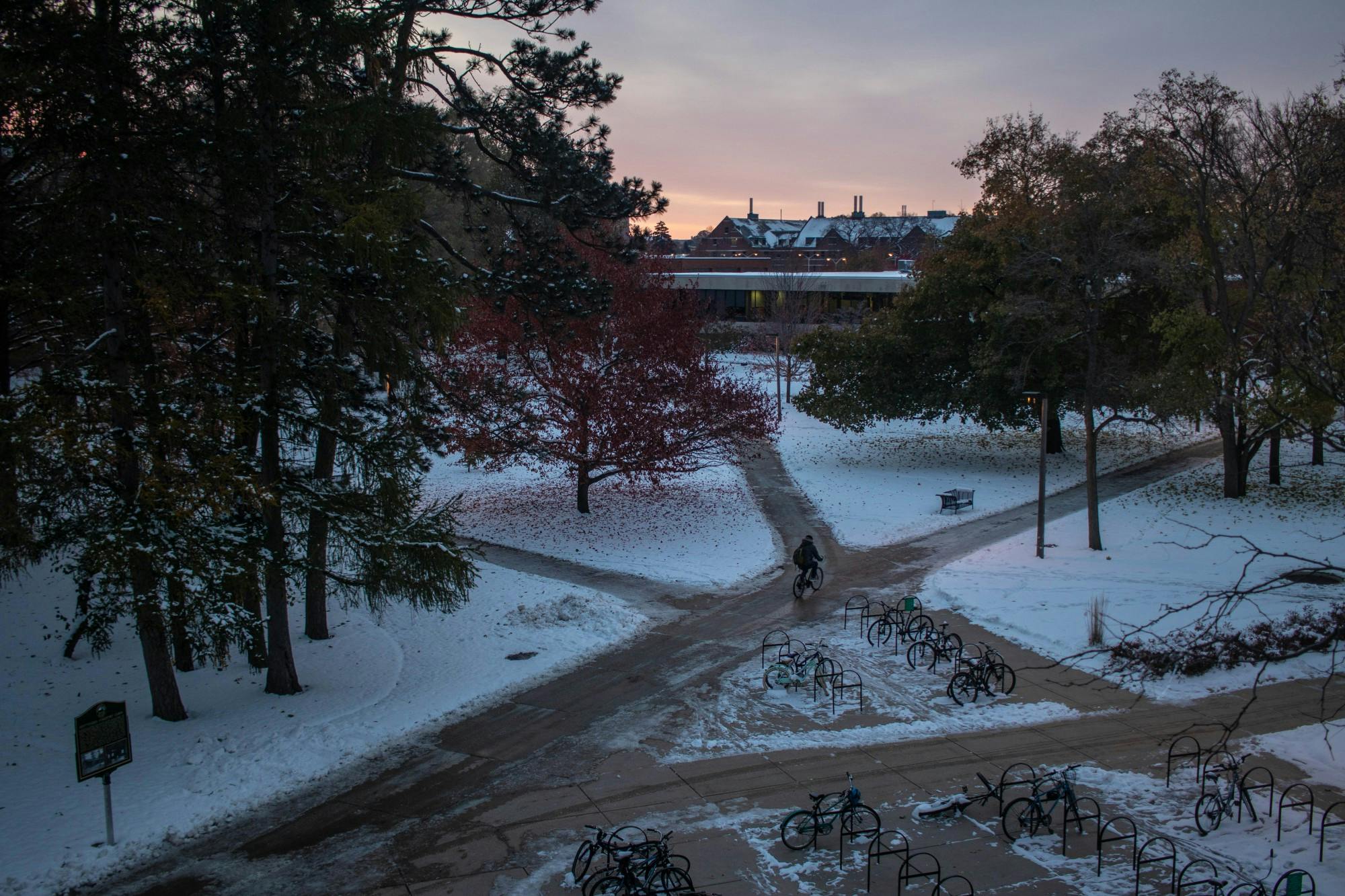 The sun rises over the sidewalk intersection between the International Center and Wells Hall on Nov. 13, 2019.