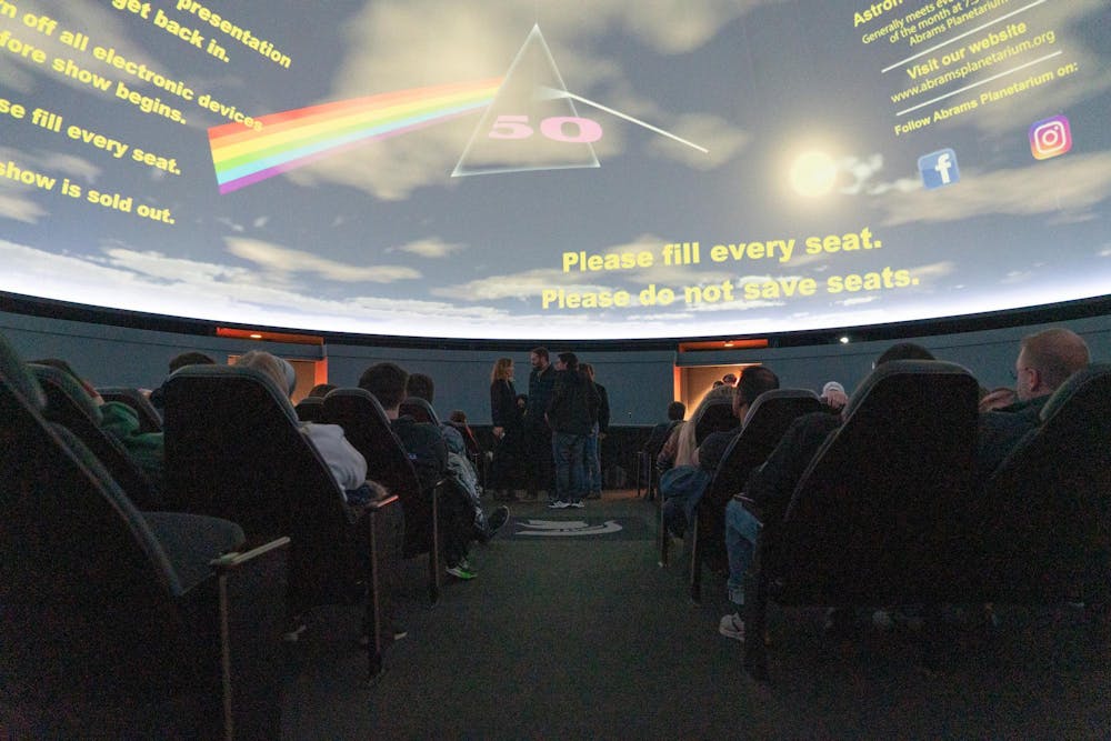 Students wait for the show to start at Abrams Planetarium on Friday, Nov. 10, 2023. The planetarium screened a show by British psychadelic rock band Pink Floyd, a visualization of their legendary 1973 album "Dark Side of the Moon" in celebration of the albums 50th birthday.