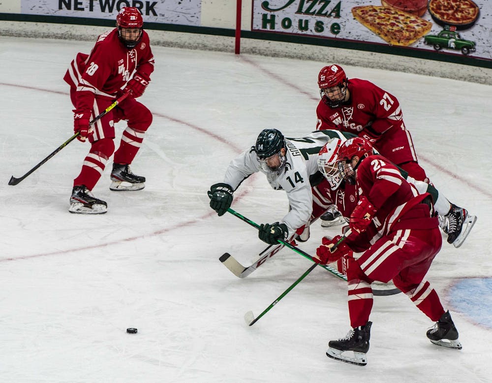 Goodsir dives to regain possession of the puck in the second period but is unsuccessful. The Badgers shut out the Spartans 4-0 at Munn Ice Arena on Mar. 5, 2021. 