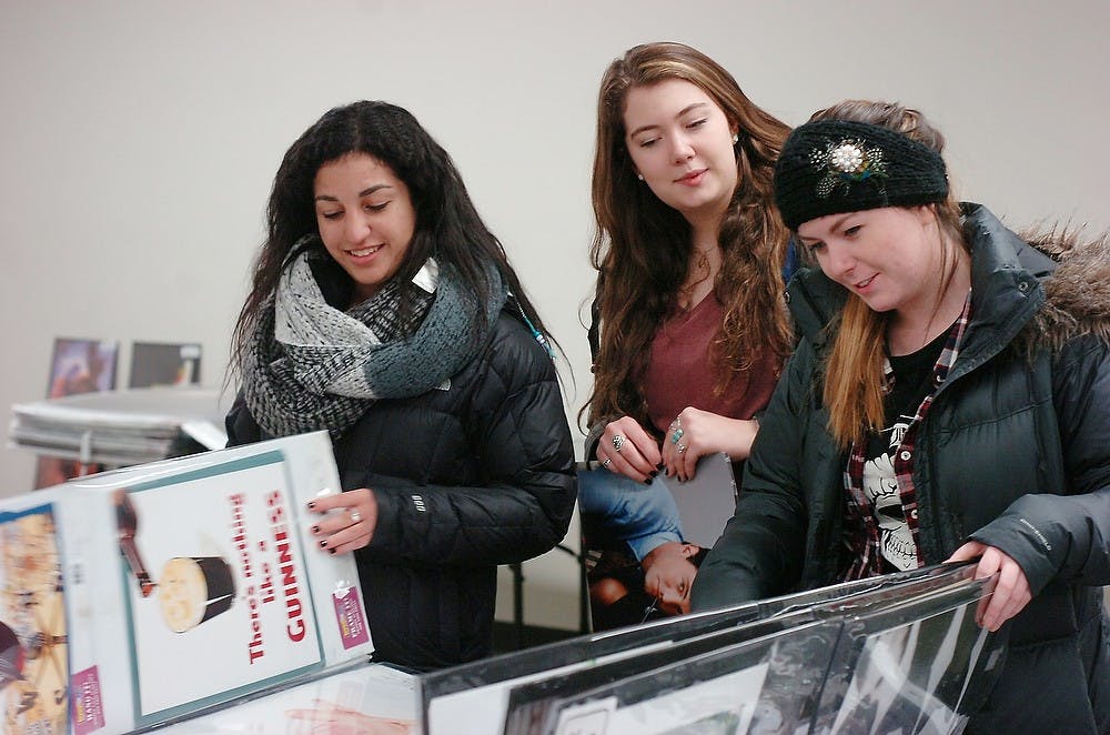 <p>From left, hospitality business sophomore Anna Margosian, special education sophomore Christina Connolly, and nursing junior Catie Ray look at posters Jan. 14, 2015, during the poster sale at the MSU Union. Jessica Steeley/The State News</p>