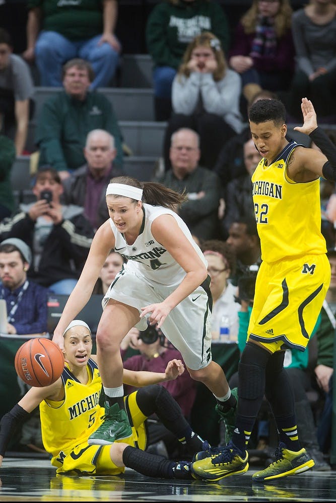 <p>Freshman guard/forward Lexi Gussert dives for the ball over Michigan guard Shannon Smith Feb 5, 2015, during the game at Breslin Center. The Spartans were defeated by the Wolverines, 72-59. Kennedy Thatch/The State News</p>