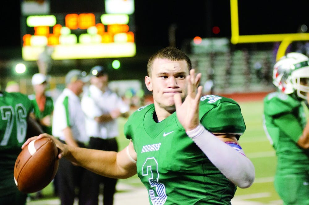 Jordan Kitna, a Waxahachie High School senior and starting quarterback, practices his throwing during a game a few weeks after breaking his collarbone in September 2015. Expected to be out the rest of the season, Kitna returned to the field about four weeks after the injury. Photo courtesy of Scott Dorsett/The Daily Light