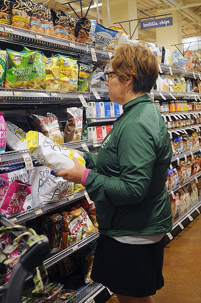 <p>East Lansing resident Kathleen Millow shops at The Fresh Thyme Farmers Market, 930 Trowbridge Road for the first time May 30, 2015. Millow said she still misses Goodrich's Shop-Rite and was sad to see them go after over 30 years of business but East Lansing was in desperate need of this new store with prepared foods and fairly affordable prices. Asha Johnson/The State News. </p>