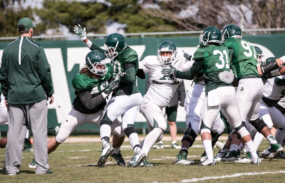 Senior tight end Jamal Lyles goes to defend offensive players during spring practice on April 12, 2016 at Skandalaris Football Center.