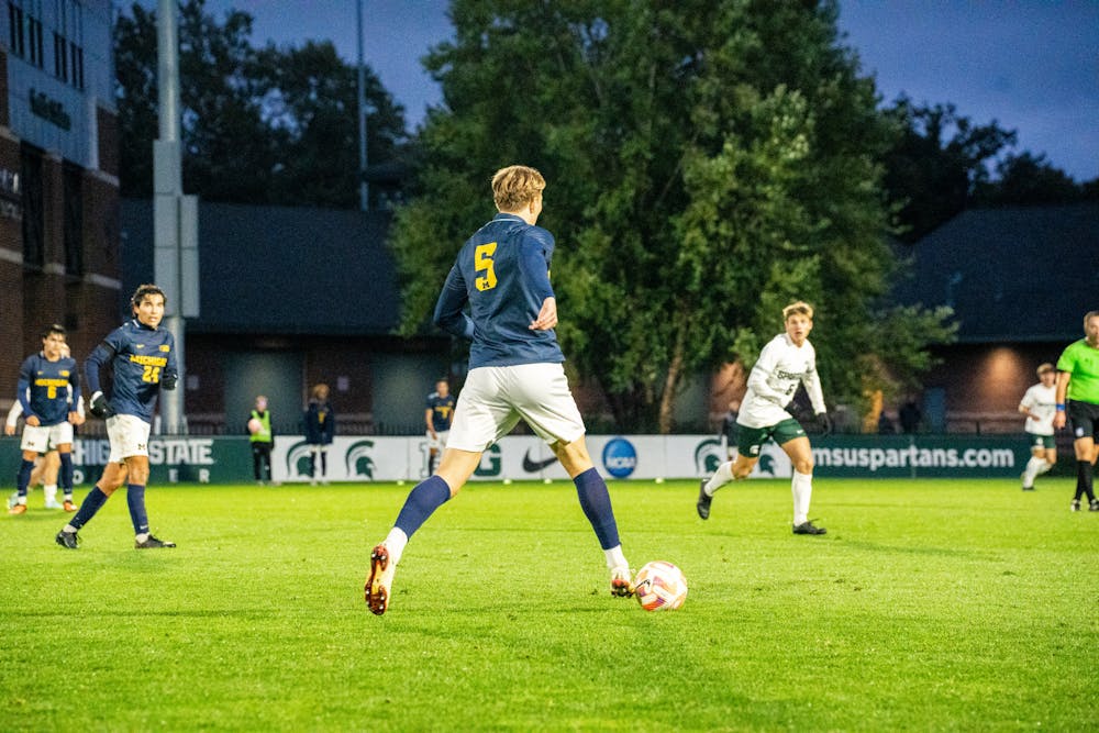 <p>University of Michigan junior defender Jens Hoff (5) dribbles the ball at DeMartin Stadium on Sept. 27, 2022. Spartans defeated the Wolverines 2-0. </p>