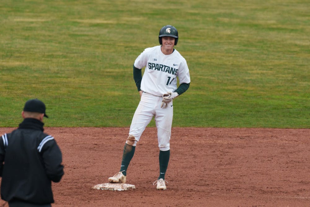 <p>Michigan State sophomore Mitch Jebb is happy to be safe on second after a close call against Youngtown State at McLane Baseball Stadium on March 30, 2022. Spartans are victorious 12-5 against Youngtown State.</p>
